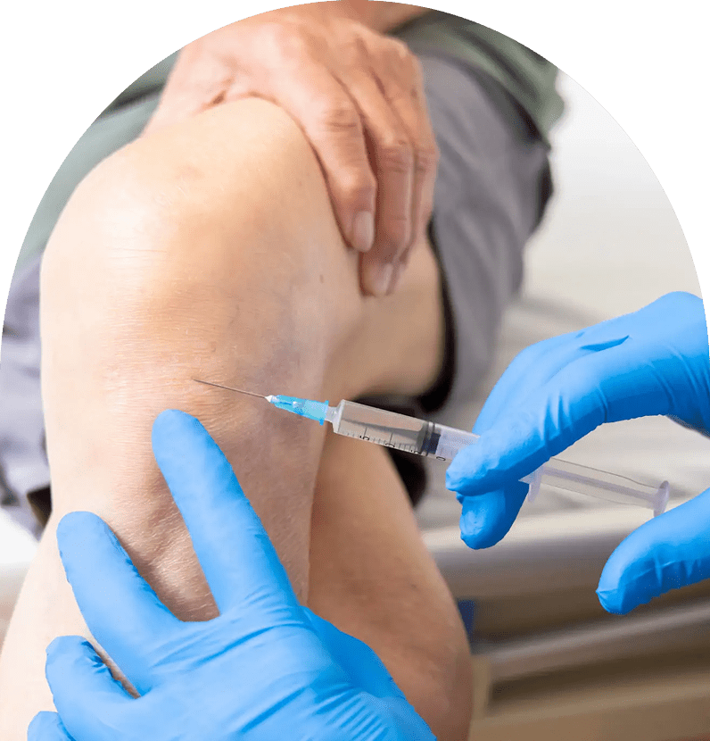 Doctor administering knee injection with syringe